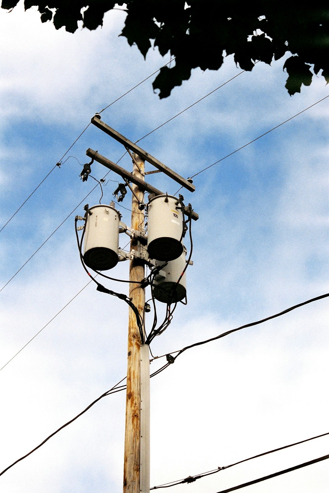Home utility-pole-with-transformers-and-wires-against-sky-iti1dbygxji